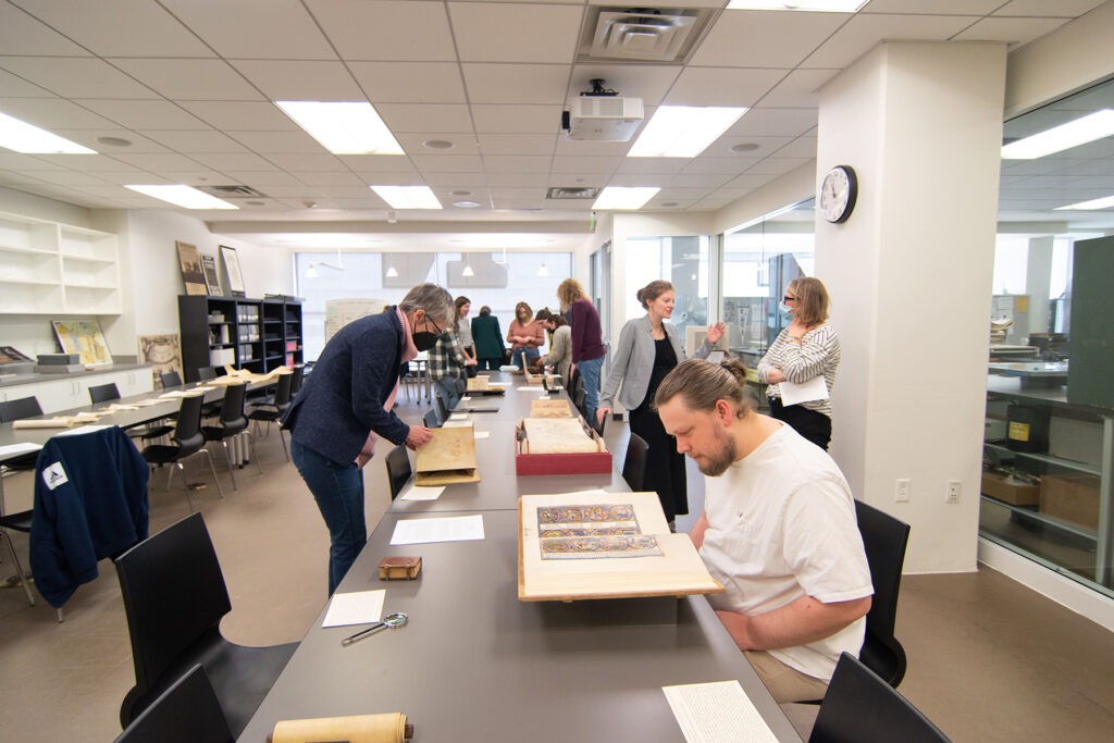 Art Historian Alexa Sand in Marriott Library Special Collections with students from Professor Meekyung MacMurdie's Medieval Art class, March 2023