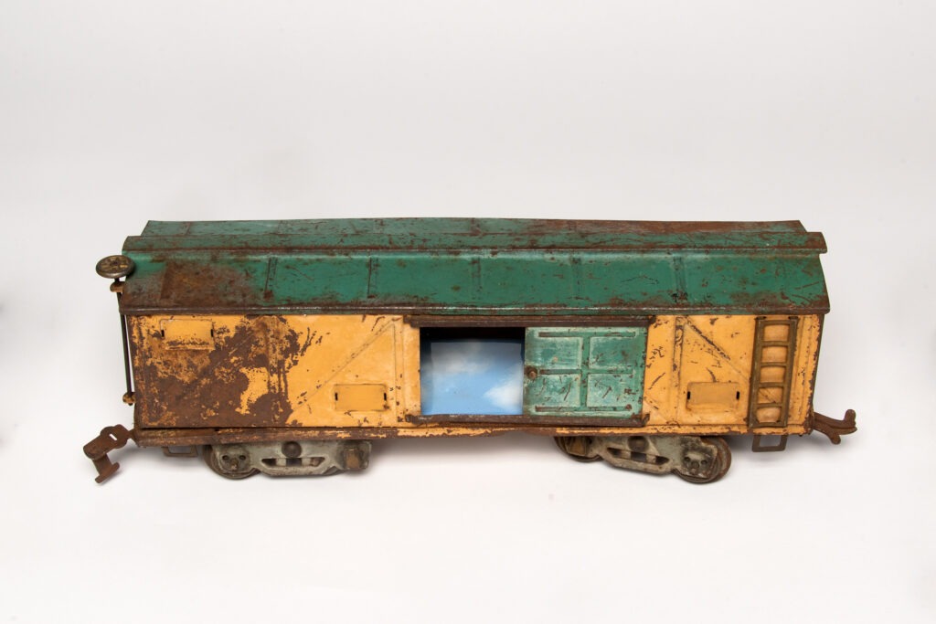 One Last Glimpse of the Sky, Beth Krensky and Zev Gorfinkle, 2023, 1929 model train, gold leaf, mica, enameled copper panels